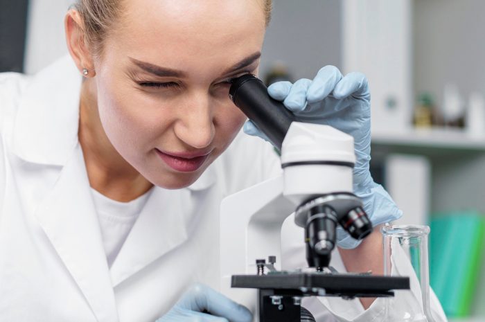 front-view-female-researcher-laboratory-with-microscope